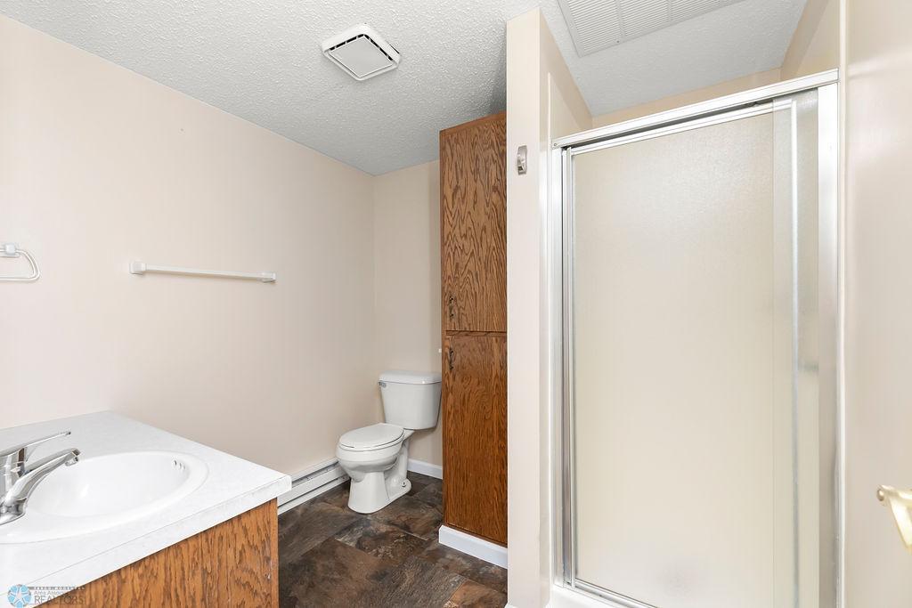 Private 3/4 Bath with walk-in shower & linen storage