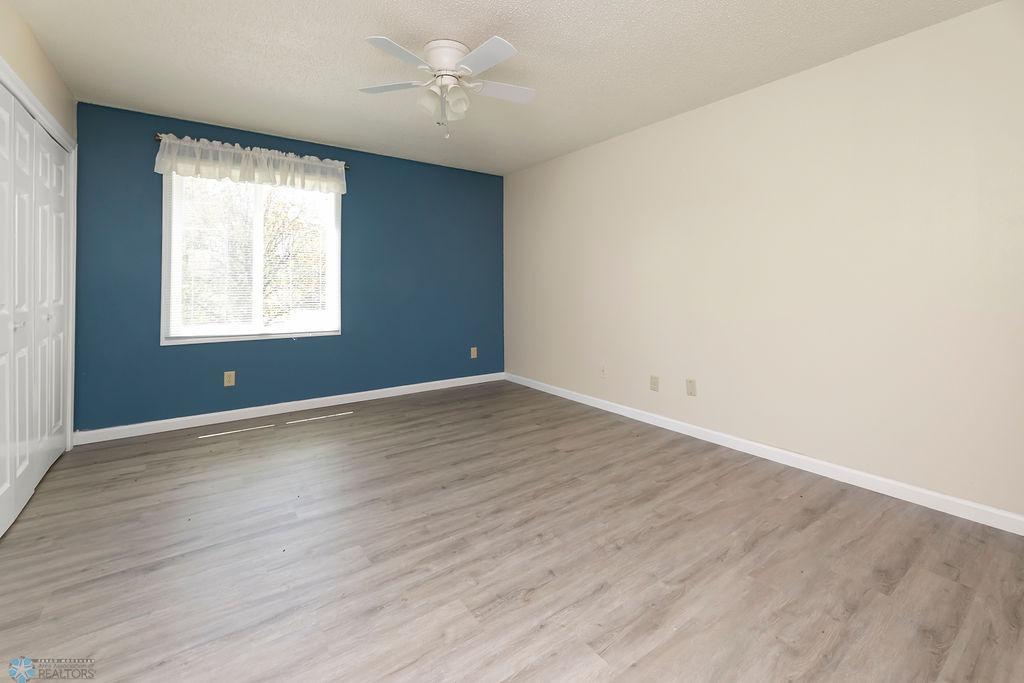 Bedroom 2-Primary Bedroom with accent wall, ceiling fan, LVP floors.