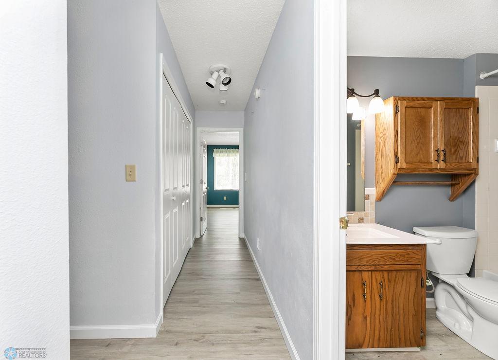 Hallway to laundry, full bath & 2 bedrooms