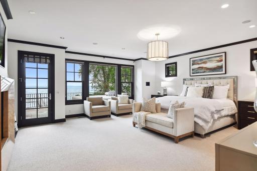 Wake up to the soothing sounds of the lake in this inviting primary bedroom.