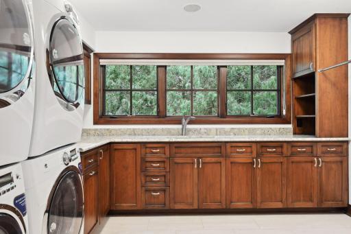 The laundry room is conveniently located on the upper level and hosts dual washers and dryers.