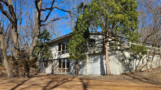 Angled pic of home/garage. Patio over entire garage.