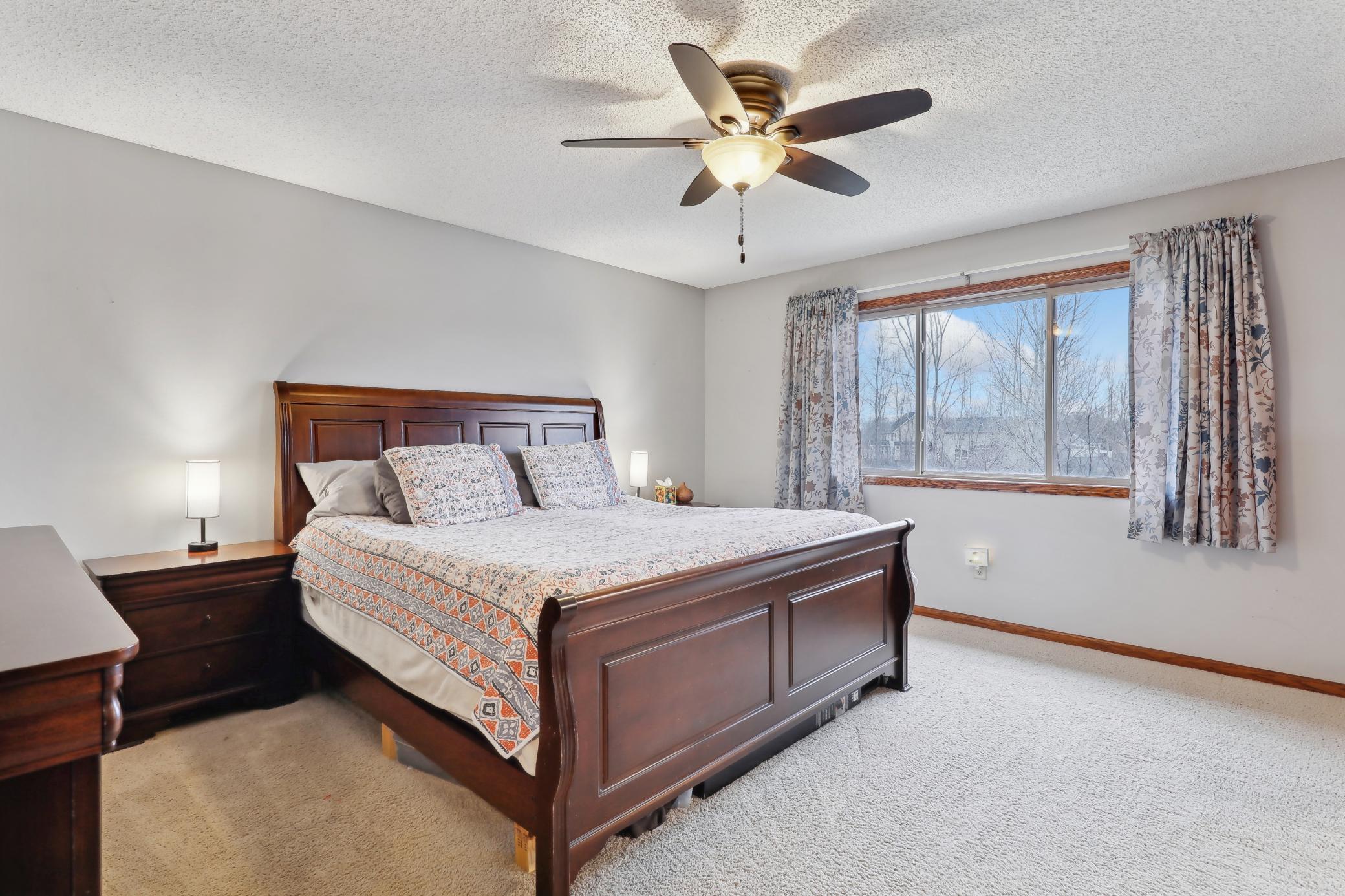 Primary bedroom with fews of pond
