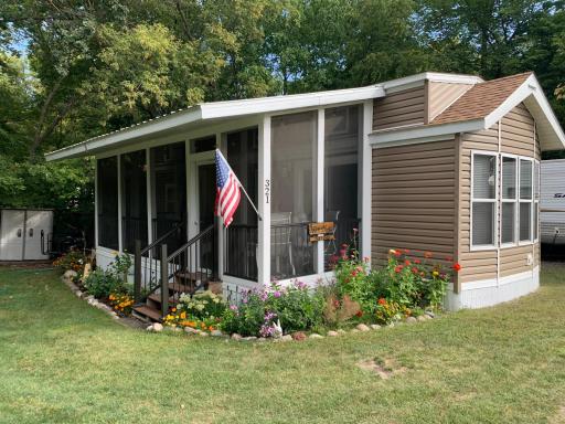 2021 Summit Park Model on beautiful large unit on "Playground Circle" in Cokato Lake RV Resort. Includes custom sun room, shed and more!