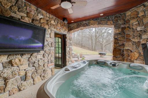 Covered patio with hot tub.