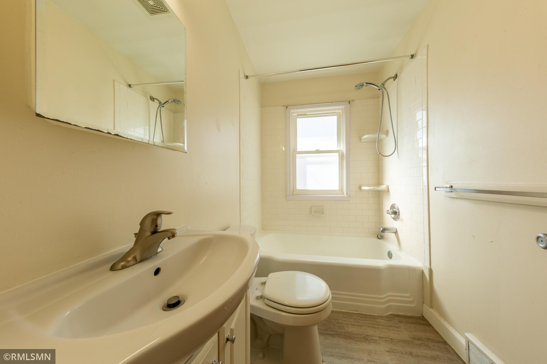 Shower has subway tile surround