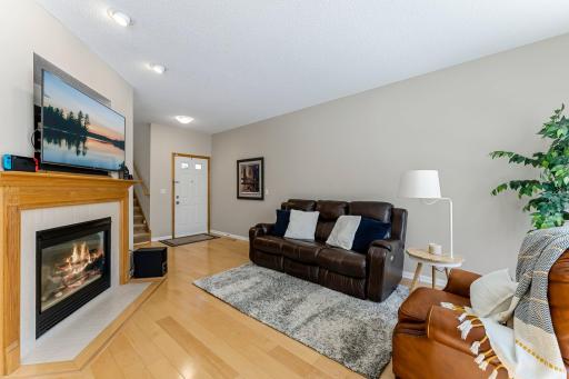 Living Room with Gleaming Hardwood Floors, Volume Ceilings, and Large Window.
