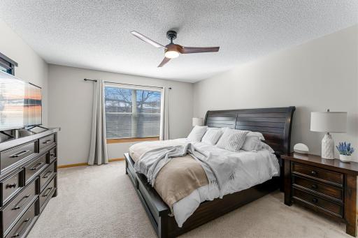 Primary Bedroom boasts 2 Closets, Large Window, and Ceiling Fan with Light.