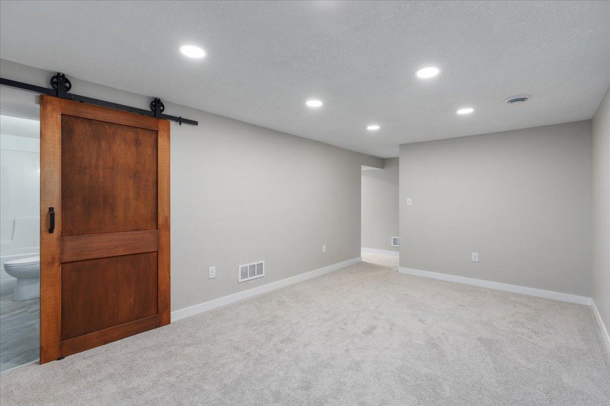 Family room located in basement with attached full bath