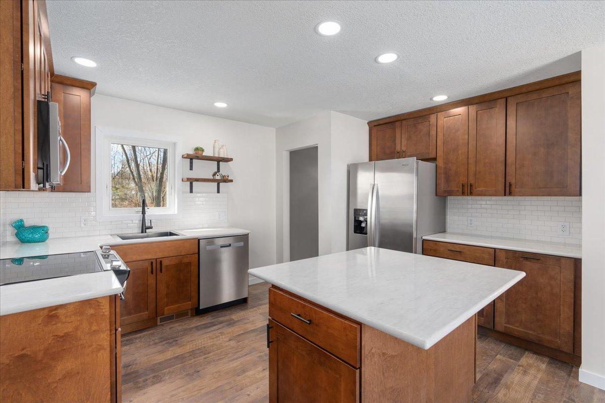 Beautifully done kitchen with door to finished basement