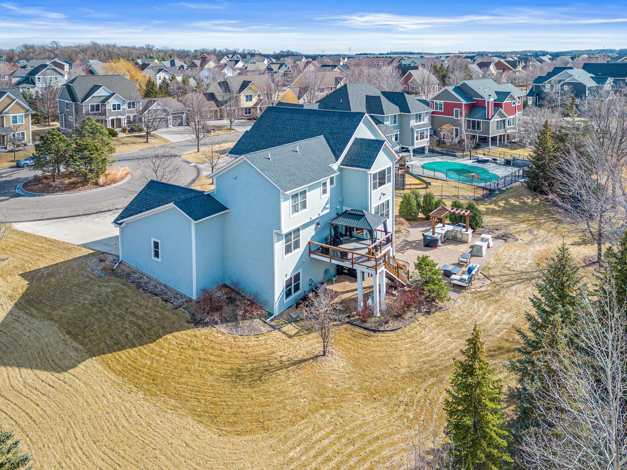 Large backyard with deck, outdoor kitchen and patio