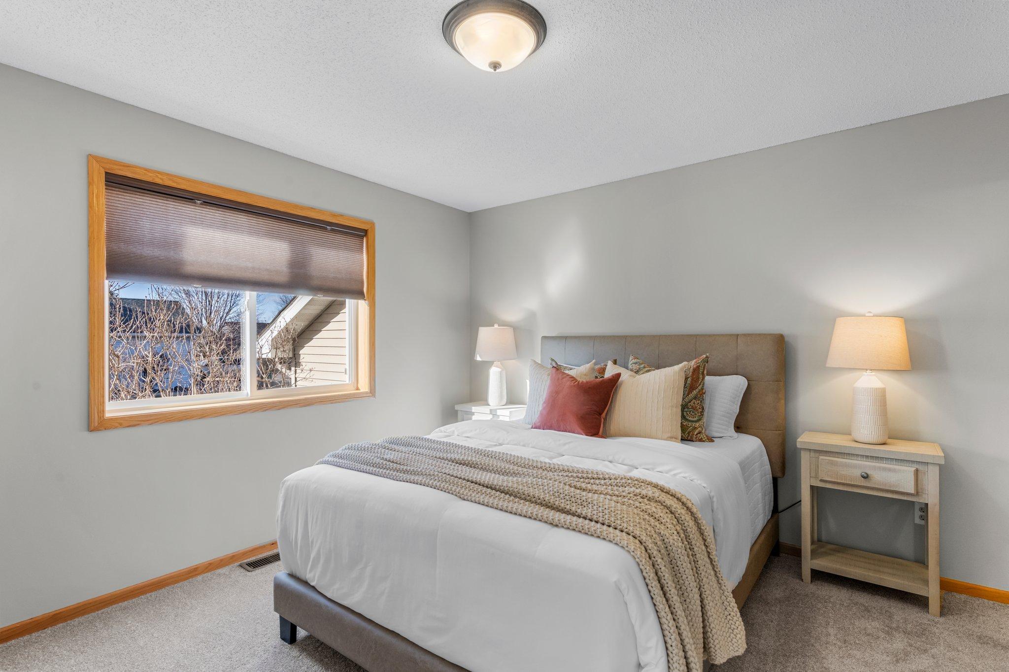 The primary bedroom features a window overlooking the side of the home, an 8x4 walk-in closet, and a private bathroom.