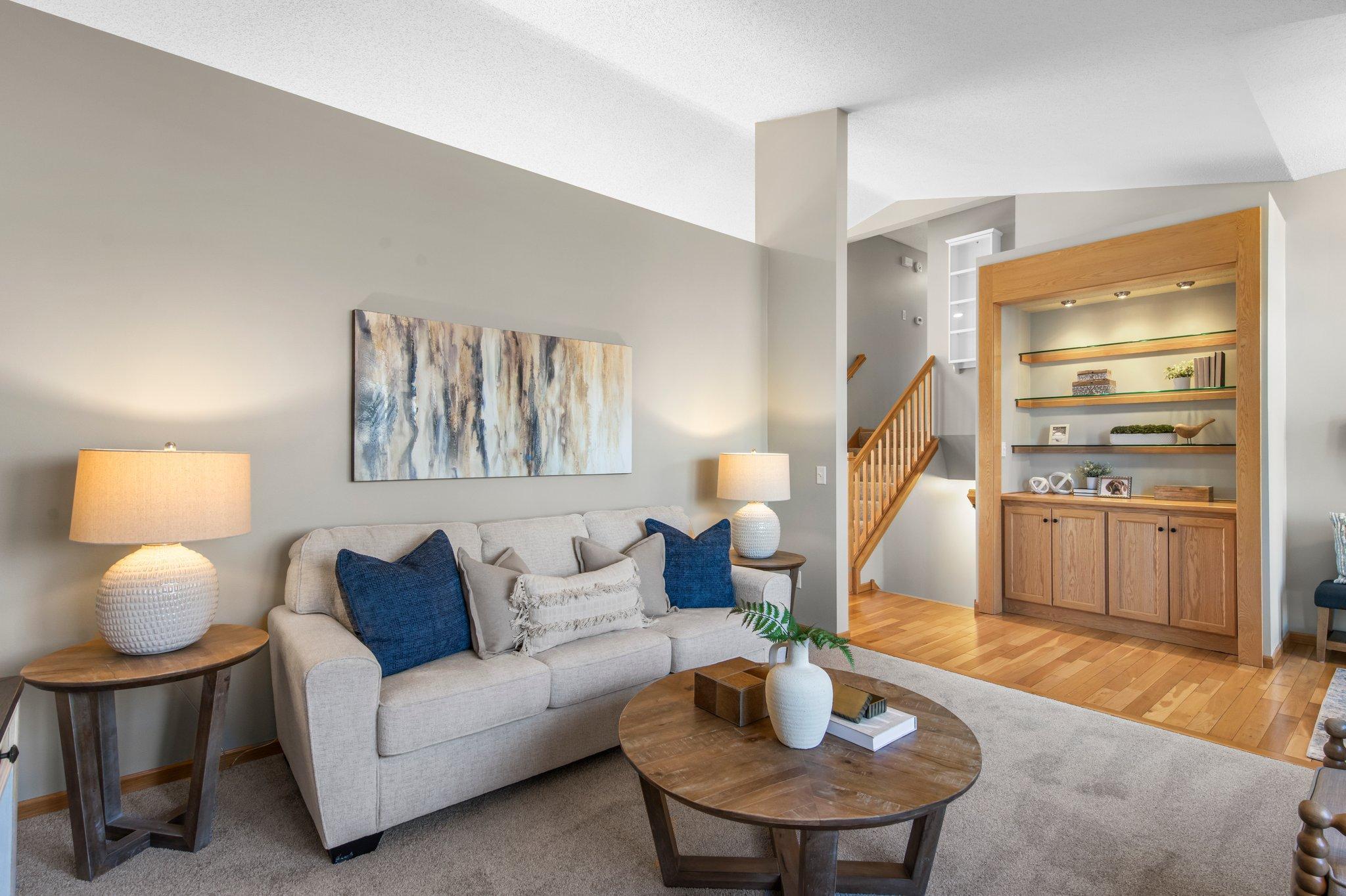 An alternate view of the living room showcasing a built-in display case and cabinetry, perfect for showcasing décor or providing additional storage.