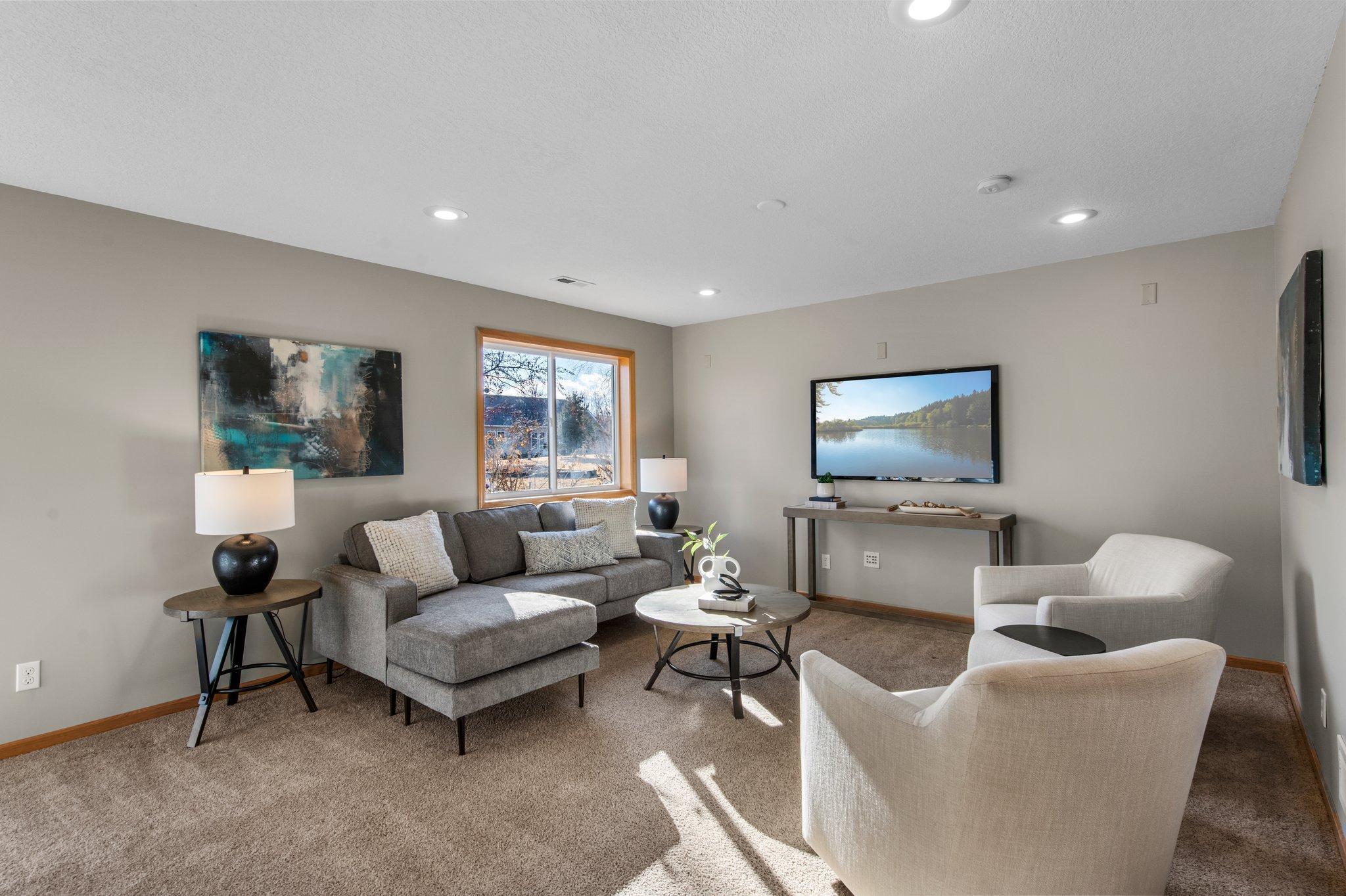 The lower-level family room is spacious and carpeted—ideal for a cozy night in or entertaining.