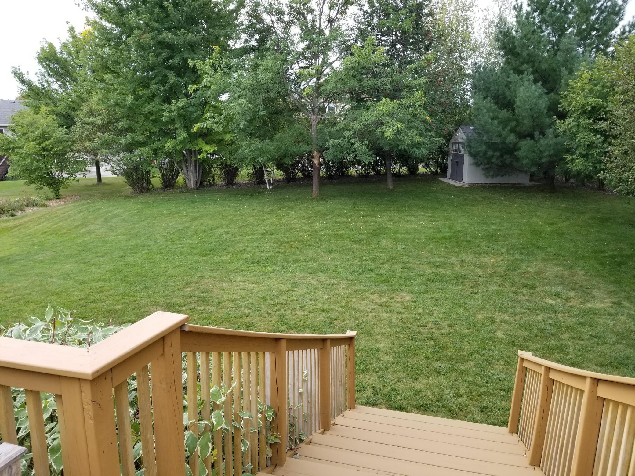 A scenic view of the backyard from the deck during the warm months.