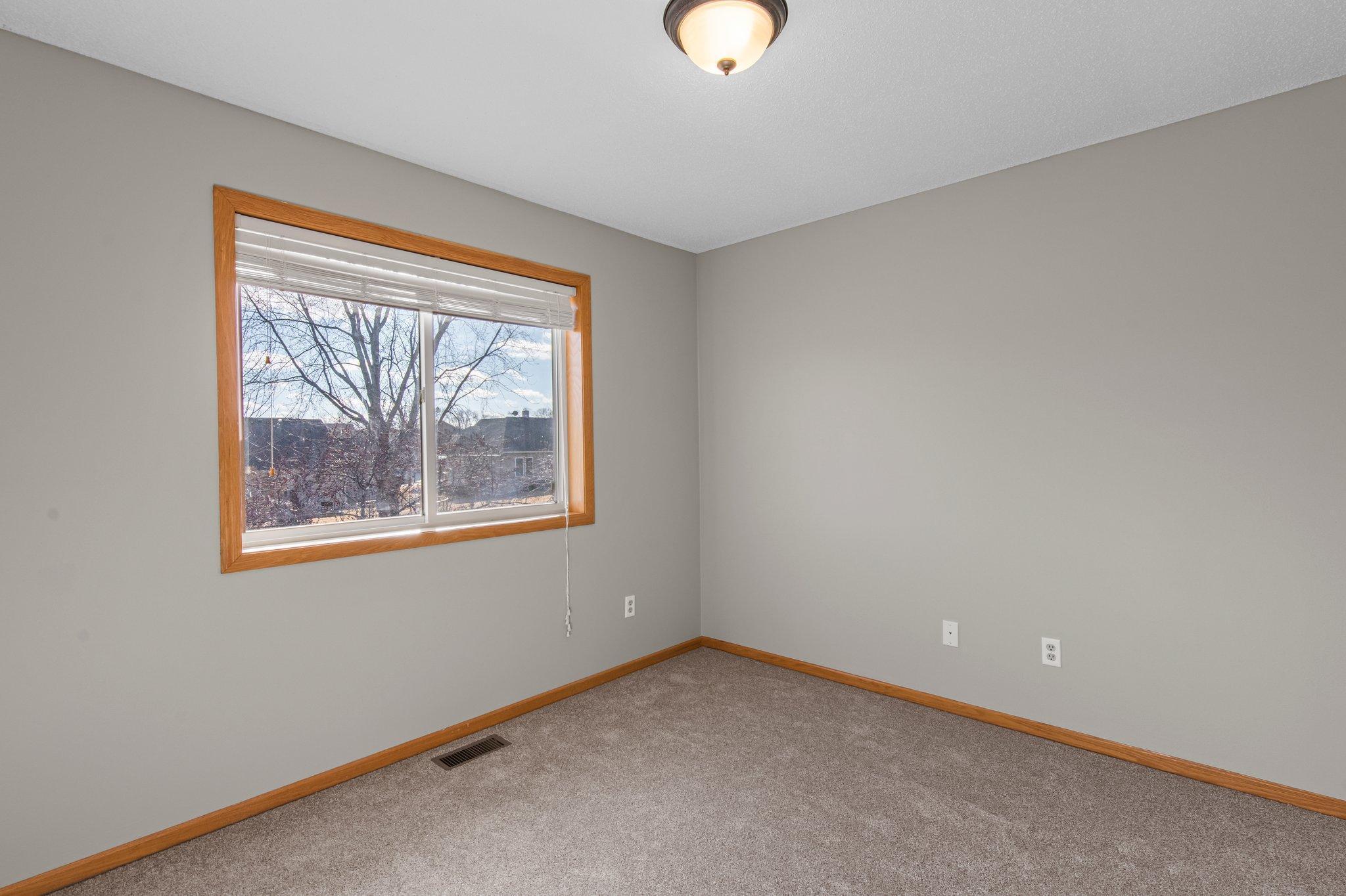 The two additional bedrooms on the upper level are carpeted, each with a window facing the back of the home, and are just steps away from a shared full bathroom.