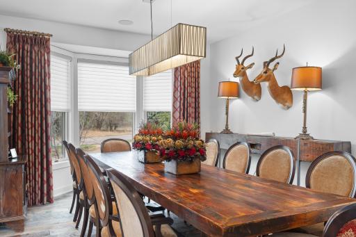 The formal dining room continues with the custom window coverings and is graced with a touch of Antelope dÃ©cor.