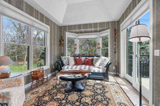 The vaulted 4-season porch also has heated floors.