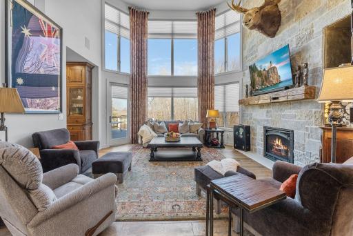 Two story foyer leads to a spacious two story great room with all custom hardwood floors and window coverings.