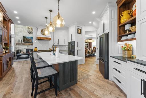 Kitchen center island with a snack bar and a farmhouse sink.