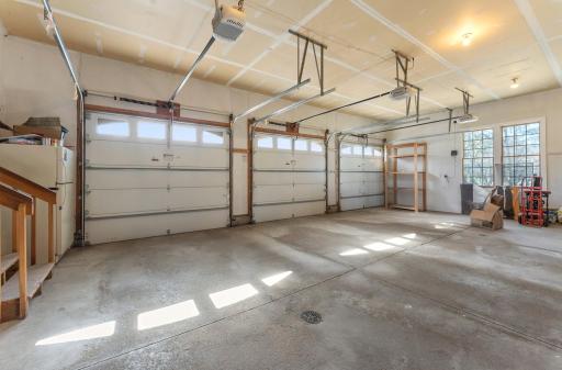The three car garage is heated, has a floor drain and three garage doors.