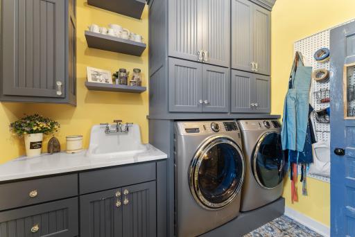Main floor laundry with fresh cabinetry, classy sink and quality appliances.