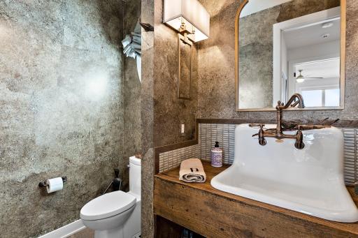 The main floor half bath is rich and impressive.