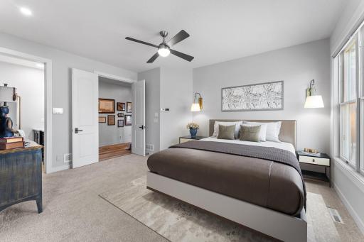 The palatial primary bedroom has French doors, a unique curved wall and a 'sitting room'.