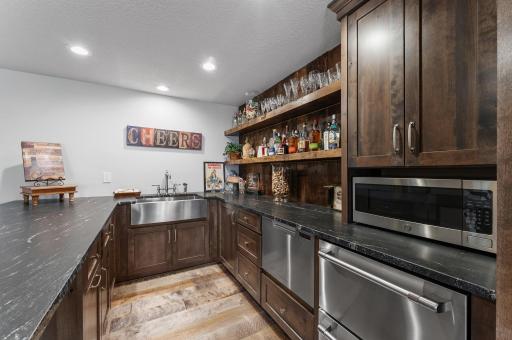The full kitchen/wet bar has all new cabinetry, countertops, stainless appliances and a matching stainless steel 'farmhouse sink'!