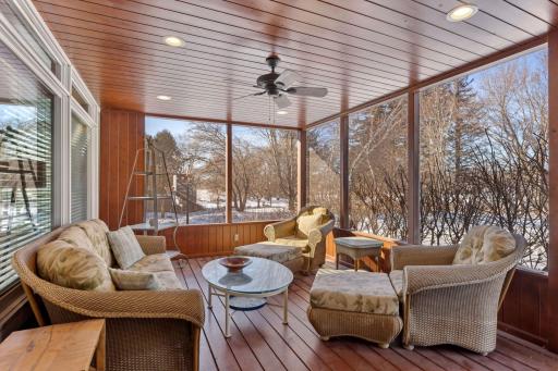 Screened-in porch off the kitchen gives you views of the sport court and the lake.iving room