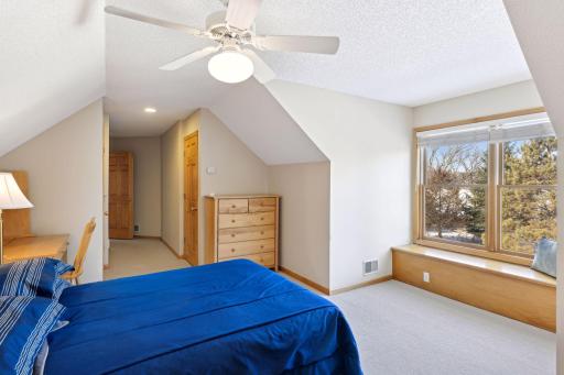 Fifth bedroom on the upper level that acts as a second primary bedroom
