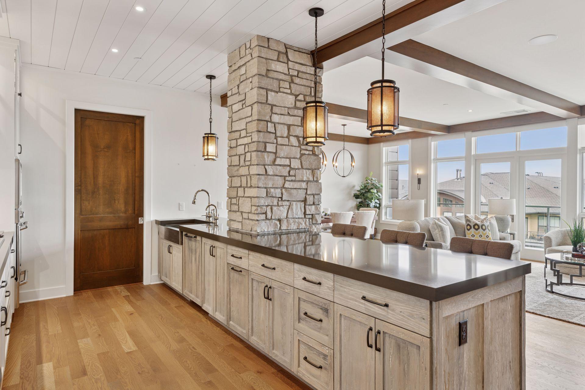 High-end appliances with paneled fronts, gas cooktop, wall oven with warming drawer, large walk-in pantry, and an oversized penninsula to gather around