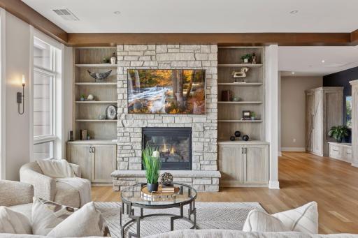 Highlights in the main areas include beautiful hardwood floors, stunning stone details, wood beams, and built-ins throughout the condo