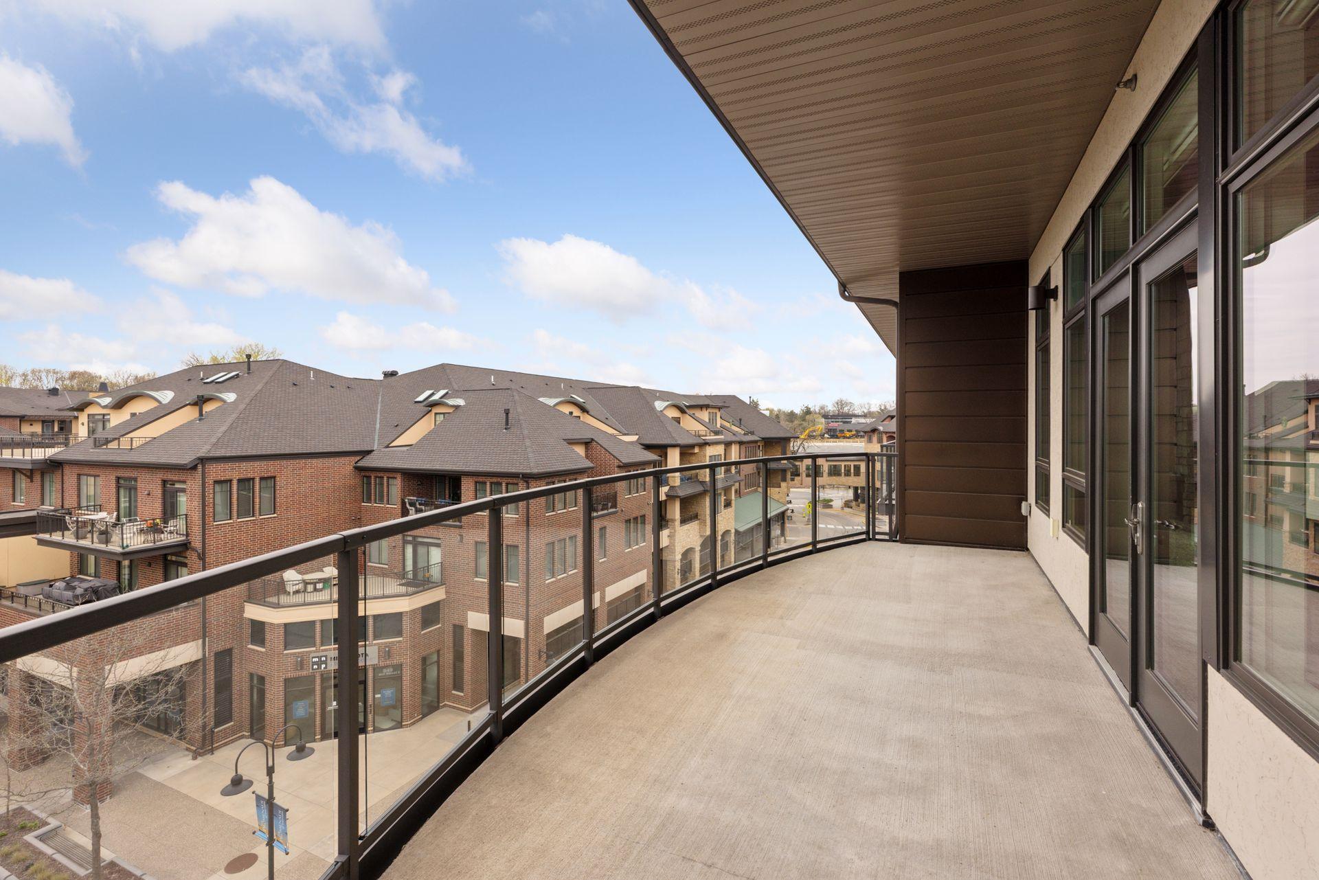 Large oversized balcony off the main living areas is a great space to take in the sunsets over Wayzata