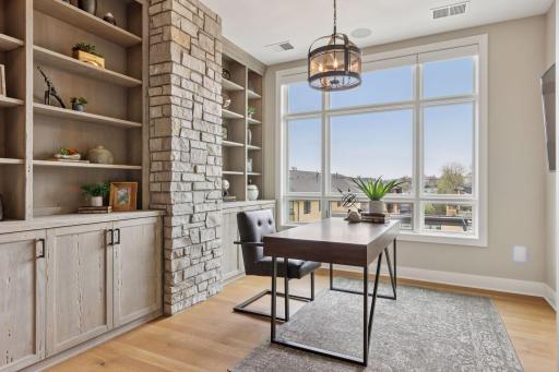 Flex space tucked behind the living area creates room for a designated home office or library