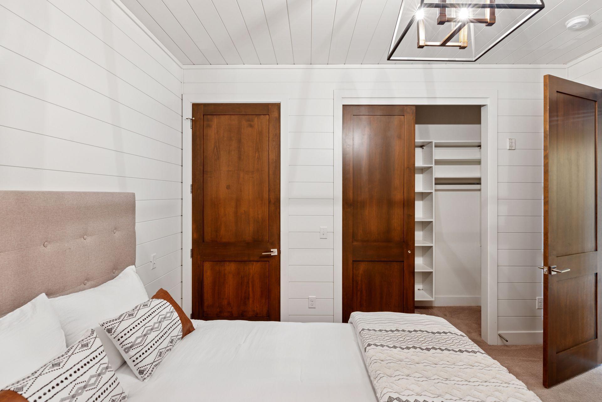 Ship lap finishes and closet components in this bedroom as well