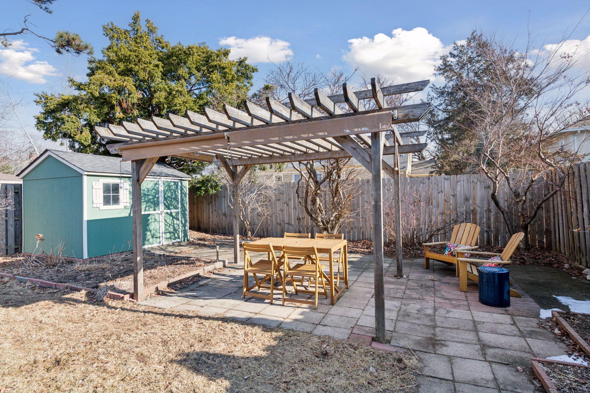 Pergola area for dining with patio space for sitting area as well.
