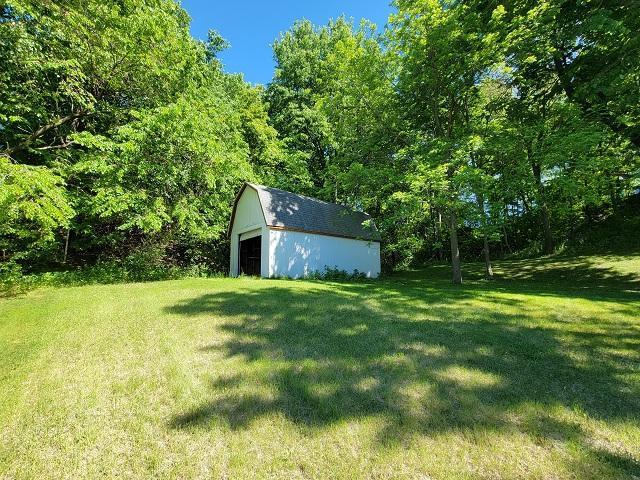 Property marker in front of shed / garage in trees