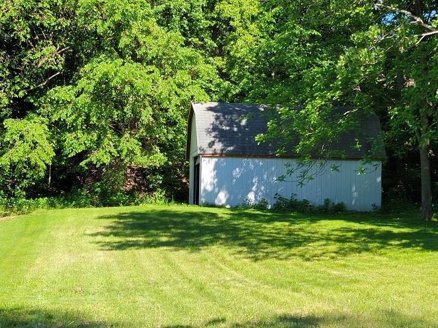 Property marker in trees just east of shed / garage