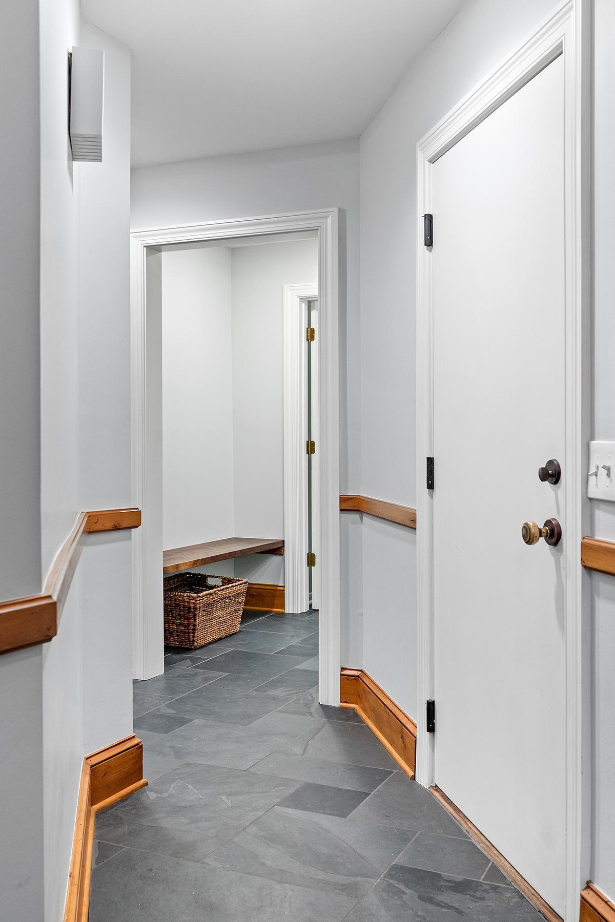 Entry from attached garage with built-in mudroom bench.