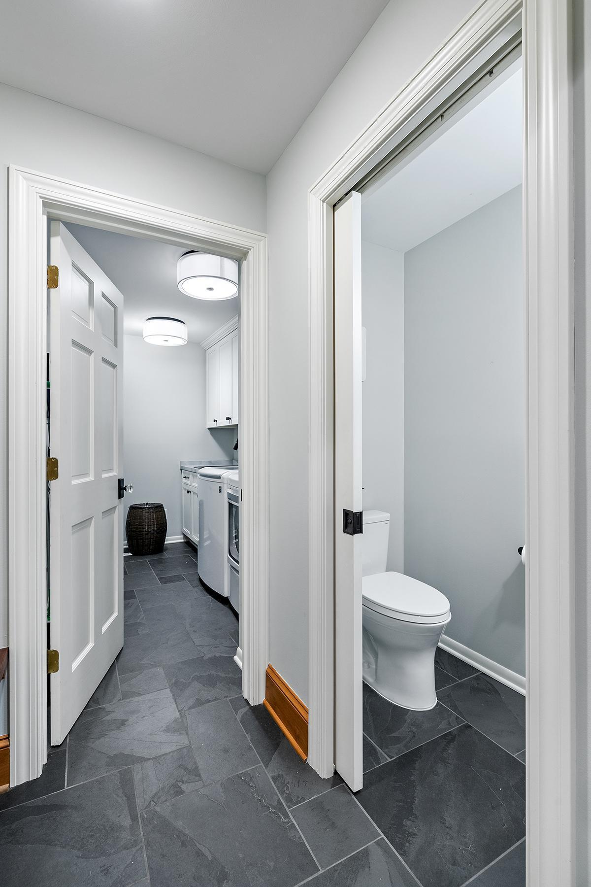Half bath with pocket doors. Generous laundry room with storage.