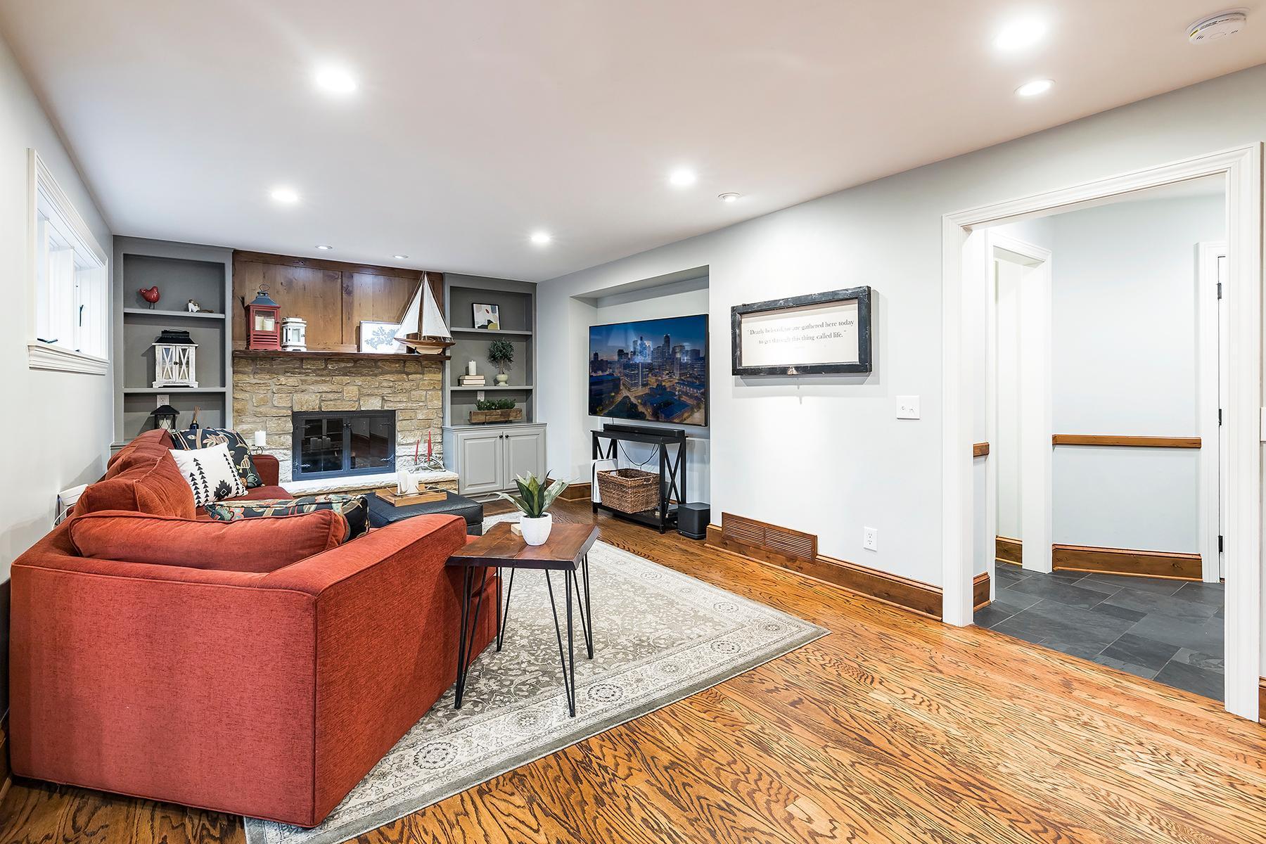 Tiled hallway off family room leads to half-bath, mudroom, laundry room, and access to attached garage.
