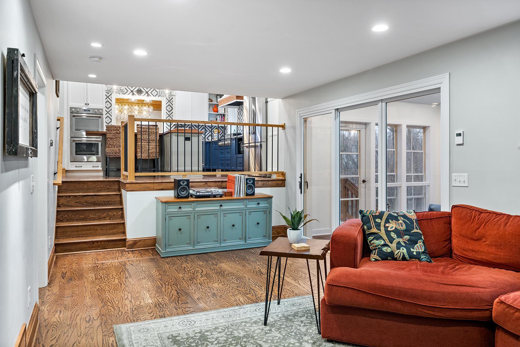 Step down to family room then out patio doors to 3-season sunroom.