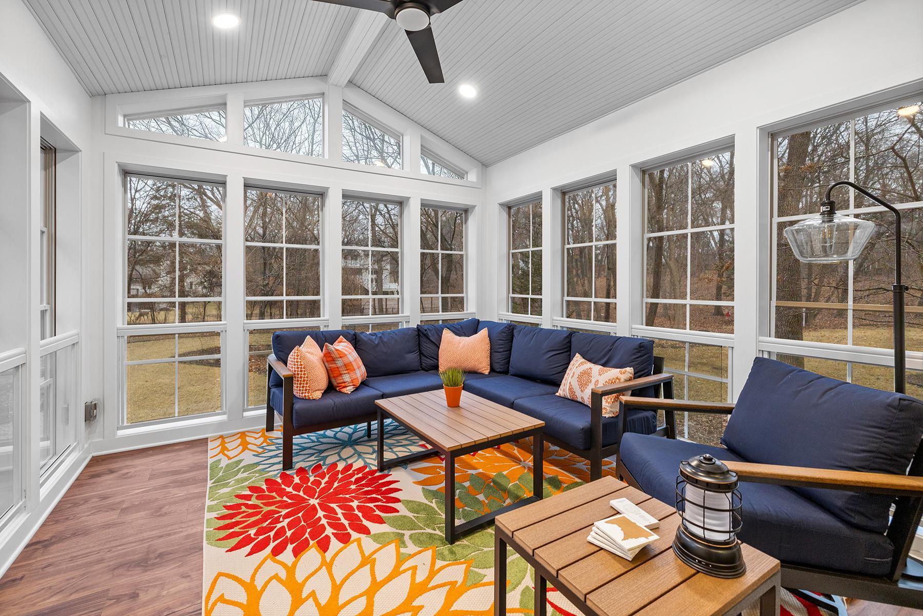 Three-season sunroom added in 2022. Surrounded by nature with doors leading to back yard patio and hot tub.