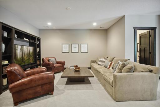 Lower level media room with recessed lighting is the perfect place for movie night