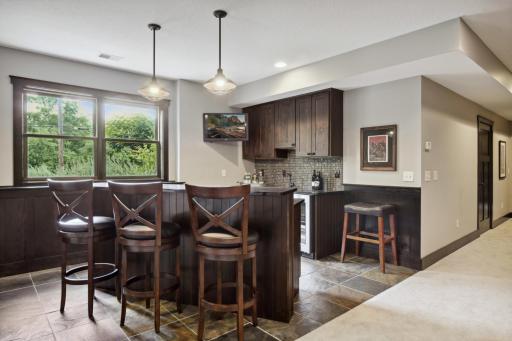 You'll love to entertain in the lower level with this walk-behind bar that easily walks out to the patio for indoor/outdoor entertaining