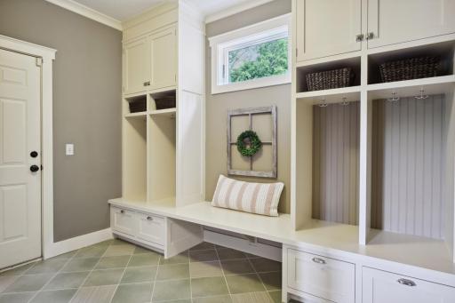 You'll love the spacious mud room featuring tile floors, built-in cubbies and walk-in closet