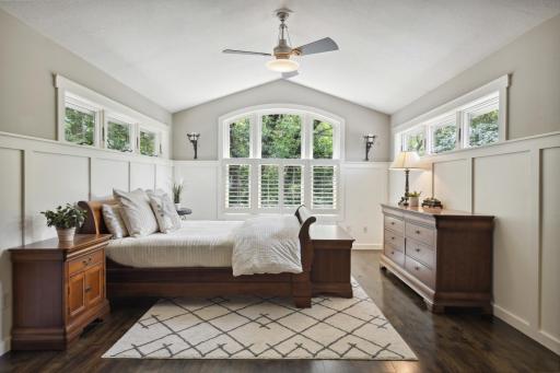Amazing owners' suite showcases vaulted ceiling, hardwood flooring, gorgeous windows and two walk-in closets