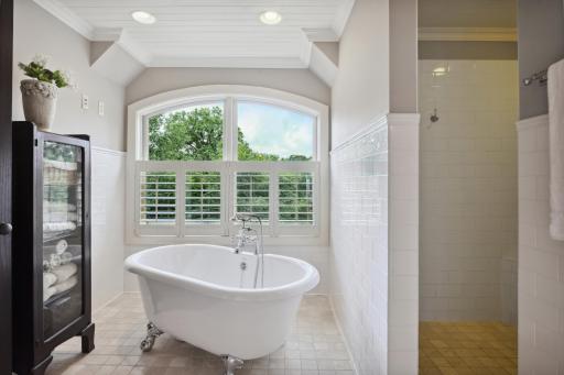 a clawfoot tub and separate walk-in shower with dual shower heads