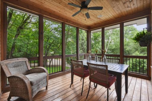 Sure to be a favorite escape, the screened porch overlooks the backyard and gardens